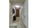 Entry hall with tile flooring, decorative accent table with lamp and a wood door at the end of the hall at 269 E Horseshoe Dr, Chandler, AZ 85249