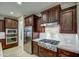 Chef's kitchen boasts stainless steel appliances, gas cooktop, and ample cabinet space for storage at 269 E Horseshoe Dr, Chandler, AZ 85249