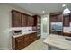 Gourmet kitchen featuring stainless steel appliances, dark wood cabinetry, and granite countertops at 269 E Horseshoe Dr, Chandler, AZ 85249