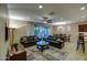 Open living room featuring comfortable leather sofas, a ceiling fan, and natural light at 269 E Horseshoe Dr, Chandler, AZ 85249