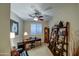 Comfortable home office featuring a wooden desk, shelving, and natural light from shuttered windows at 269 E Horseshoe Dr, Chandler, AZ 85249