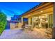 Covered outdoor patio with kitchen, grill, dining set, and view of interior living space at 269 E Horseshoe Dr, Chandler, AZ 85249
