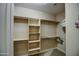 A functional walk-in closet with built-in shelves, rods, and ample storage space at 269 E Horseshoe Dr, Chandler, AZ 85249