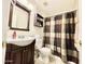 Well-lit bathroom featuring a modern vanity with dark wood cabinets and a tiled floor at 2735 E Harwell Rd, Gilbert, AZ 85234
