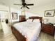 Inviting bedroom featuring a queen bed, wood floors, a ceiling fan and lots of natural light at 2735 E Harwell Rd, Gilbert, AZ 85234