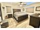 Bedroom featuring a large bed with wooden headboard, a ceiling fan and neutral decor at 2735 E Harwell Rd, Gilbert, AZ 85234
