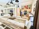 Open floor plan dining area with a rustic wood table, and an adjoining kitchen and living room at 2735 E Harwell Rd, Gilbert, AZ 85234