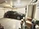A car parked in the garage filled with boxes, shelving and storage at 2735 E Harwell Rd, Gilbert, AZ 85234