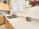 Bright kitchen features a stainless steel sink with chrome faucet and light wood cabinets at 2735 E Harwell Rd, Gilbert, AZ 85234