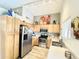 Modern kitchen with stainless steel appliances, light wood cabinets, and tile flooring at 2735 E Harwell Rd, Gilbert, AZ 85234