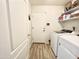 Laundry area with modern washer and dryer, shelving, and wood-look tile flooring at 2735 E Harwell Rd, Gilbert, AZ 85234
