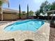 Backyard swimming pool surrounded by concrete and rock landscaping at 2735 E Harwell Rd, Gilbert, AZ 85234