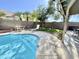 Beautiful backyard featuring a sparkling swimming pool, lounge chairs, and a patio area at 2735 E Harwell Rd, Gilbert, AZ 85234