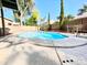 Beautiful private pool surrounded by a concrete patio, with a grass area in the background at 2735 E Harwell Rd, Gilbert, AZ 85234