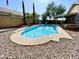 Backyard swimming pool surrounded by concrete and rock landscaping at 2735 E Harwell Rd, Gilbert, AZ 85234