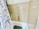 A shower with a leaf-patterned curtain and textured walls at 2735 E Harwell Rd, Gilbert, AZ 85234