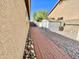 Side yard featuring a brick walkway, gravel landscaping, and storage shed at 2735 E Harwell Rd, Gilbert, AZ 85234