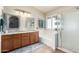 Bright bathroom with double sinks, granite countertops, separate shower and tub, tile floors, and natural light at 288 E Baylor Ln, Gilbert, AZ 85296