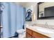 Bathroom featuring a shower with blue curtain, tile floor, granite vanity, and decorative artwork and lighting at 288 E Baylor Ln, Gilbert, AZ 85296