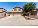 Charming two-story home featuring a three-car garage, desert landscaping, and a welcoming facade at 288 E Baylor Ln, Gilbert, AZ 85296