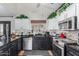 Modern kitchen features sleek black countertops, stainless steel appliances, and white cabinets at 288 E Baylor Ln, Gilbert, AZ 85296