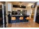 Bright kitchen featuring stainless steel appliances, breakfast bar, and wood floors at 288 E Baylor Ln, Gilbert, AZ 85296
