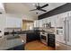 Well-lit kitchen with granite counters, stainless steel appliances and modern cabinets at 288 E Baylor Ln, Gilbert, AZ 85296