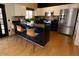 Well-equipped kitchen features a stainless steel refrigerator and a breakfast bar at 288 E Baylor Ln, Gilbert, AZ 85296