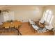 Bright living room boasts ample natural light, wood floors, a dining table, and modern furniture at 288 E Baylor Ln, Gilbert, AZ 85296