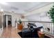 Cozy loft area with comfortable seating, black metal railing, wood-look flooring, and ample natural light at 288 E Baylor Ln, Gilbert, AZ 85296
