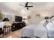 Inviting main bedroom features a ceiling fan, plantation shutters, and an entertainment center for a relaxing atmosphere at 288 E Baylor Ln, Gilbert, AZ 85296