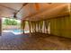 Relaxing covered patio featuring brick pavers, privacy curtains, and a view of the sparkling swimming pool at 288 E Baylor Ln, Gilbert, AZ 85296