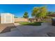 Cozy backyard with stone landscaping, storage shed, and a small sport court at 3 S 130Th Pl, Chandler, AZ 85225