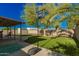 Spacious backyard with artificial turf, a basketball hoop, a shed, and mature landscaping at 3 S 130Th Pl, Chandler, AZ 85225