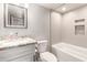 Clean bathroom featuring tiled shower with a large bathtub, white vanity with granite top, and mirror at 3 S 130Th Pl, Chandler, AZ 85225