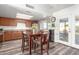 Eat-in kitchen dining area with a table and chairs, wood laminate floors, and backyard access at 3 S 130Th Pl, Chandler, AZ 85225