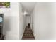 Bright hallway with wood laminate floors and white walls leading to the bedrooms at 3 S 130Th Pl, Chandler, AZ 85225
