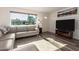 Comfortable living room with wood laminate floors, lots of light, and a cozy couch at 3 S 130Th Pl, Chandler, AZ 85225