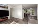 Open-concept living space with wood laminate floors and access to the kitchen and backyard at 3 S 130Th Pl, Chandler, AZ 85225