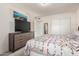Bright main bedroom with a large dresser and a large sliding door closet offering plenty of storage space at 3 S 130Th Pl, Chandler, AZ 85225