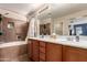 Bathroom featuring double sinks, tile flooring, and a shower-tub combo at 3272 E Tyson St, Gilbert, AZ 85295
