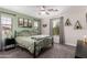 Serene bedroom featuring soft green walls, large windows, and plush carpet at 3272 E Tyson St, Gilbert, AZ 85295