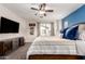 Bright bedroom featuring a ceiling fan, a large TV and a stylish cabinet for storage at 3272 E Tyson St, Gilbert, AZ 85295