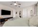 Comfortable bedroom with a flat-screen TV, soft carpet, and a ceiling fan at 3272 E Tyson St, Gilbert, AZ 85295