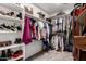 Walk-in closet with ample hanging space and shelving for shoes and accessories at 3272 E Tyson St, Gilbert, AZ 85295