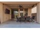 Well-appointed covered patio for outdoor dining, with ceiling fan and sliding glass door at 3272 E Tyson St, Gilbert, AZ 85295