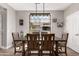 Bright dining room showcases a modern chandelier and views of the neighborhood through a large window at 3272 E Tyson St, Gilbert, AZ 85295