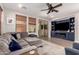 Inviting living room with a large sectional sofa, custom built-ins, and a sliding glass door at 3272 E Tyson St, Gilbert, AZ 85295