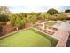 Aerial backyard view of a putting green, gardens, and trees in a landscaped yard at 3306 E Jaeger Cir, Mesa, AZ 85213
