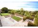 Aerial backyard view of a putting green, garden, and patios in a beautifully landscaped yard at 3306 E Jaeger Cir, Mesa, AZ 85213